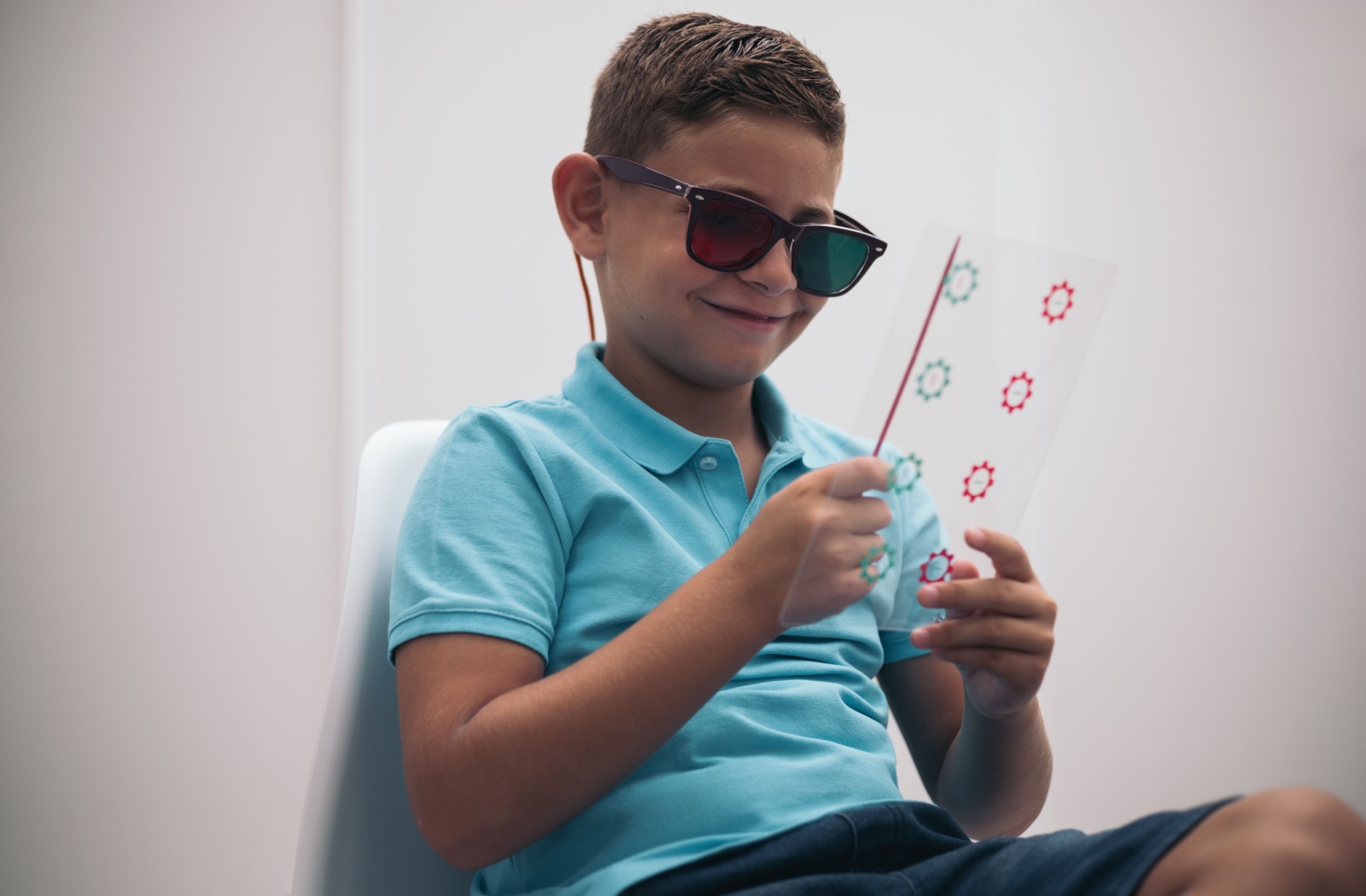 A young boy completes a convergence eye exercise during his vision therapy session.