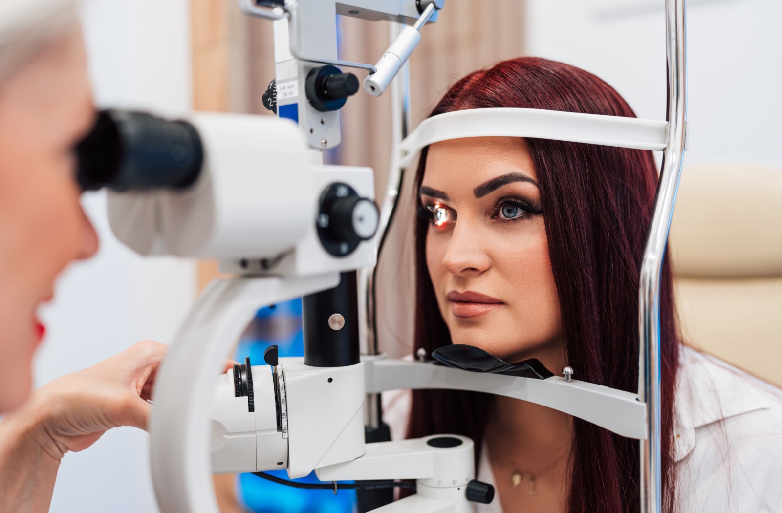 Patient with blue eyes undergoing an eye exam with an optometrist.