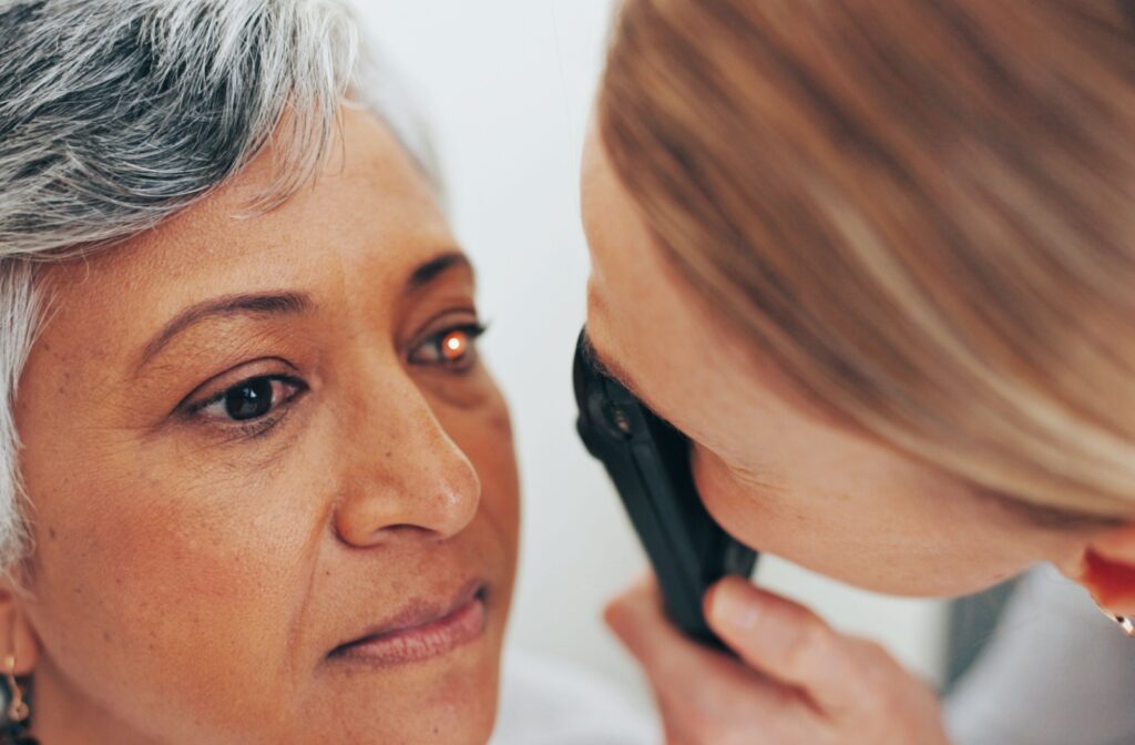 A person with short grey hair gets their eyesight tested by a doctor at Oxford Optometry.